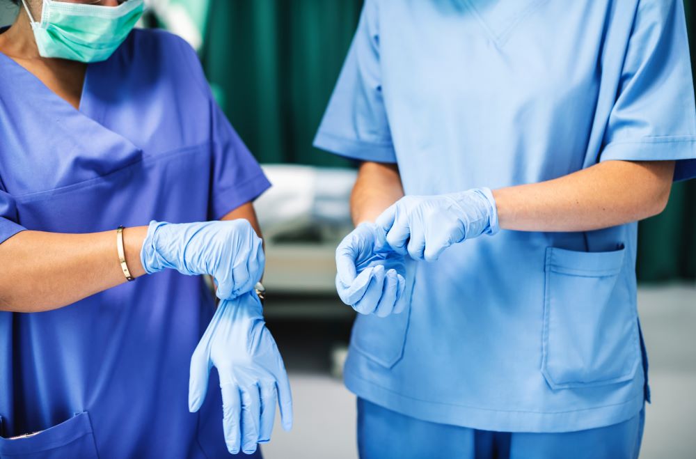 surgeons putting on gloves before going into a surgery